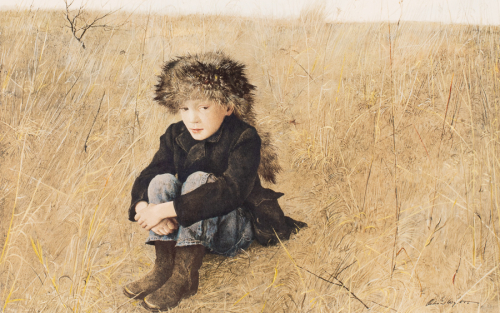 Young boy in field sitting with arms around knees wearing raccoon skin cap.
