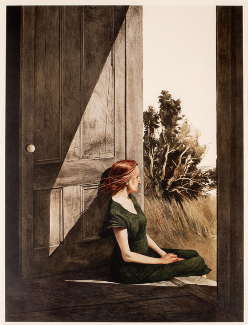 Woman wearing a green dress sitting in an open doorway. Wood of door/house is natural,  faded grey