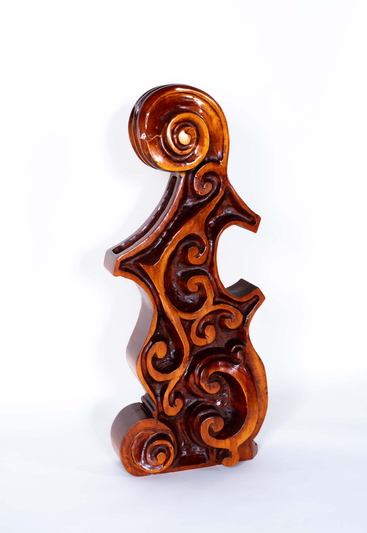 wooden work with swirling designs carved into it